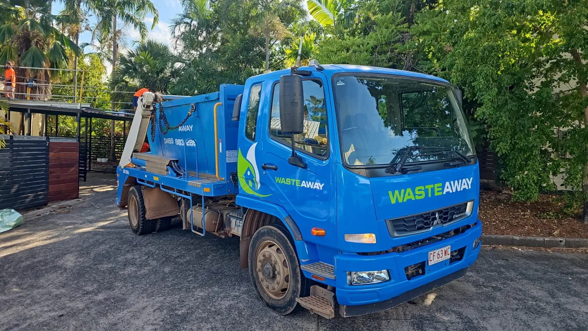 Blue NT Waste Away Fuso skip truck at a local property