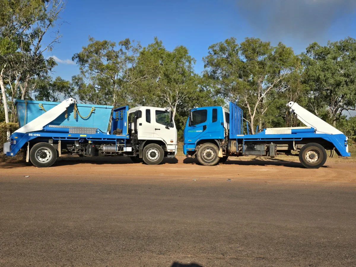 Two branded NT Waste Away trucks parked together